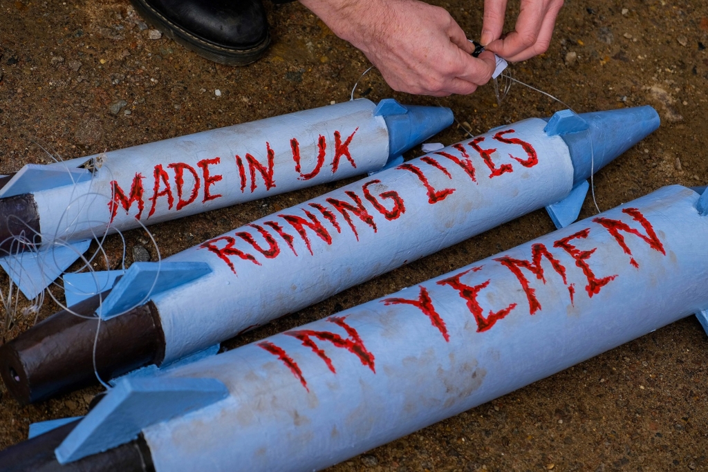 Three fake missles that were used as props at an Amnesty International protest against the sale of arms to human rights abuses. Across the missiles reads, Made in the UK: Ruining Lives in Yemen