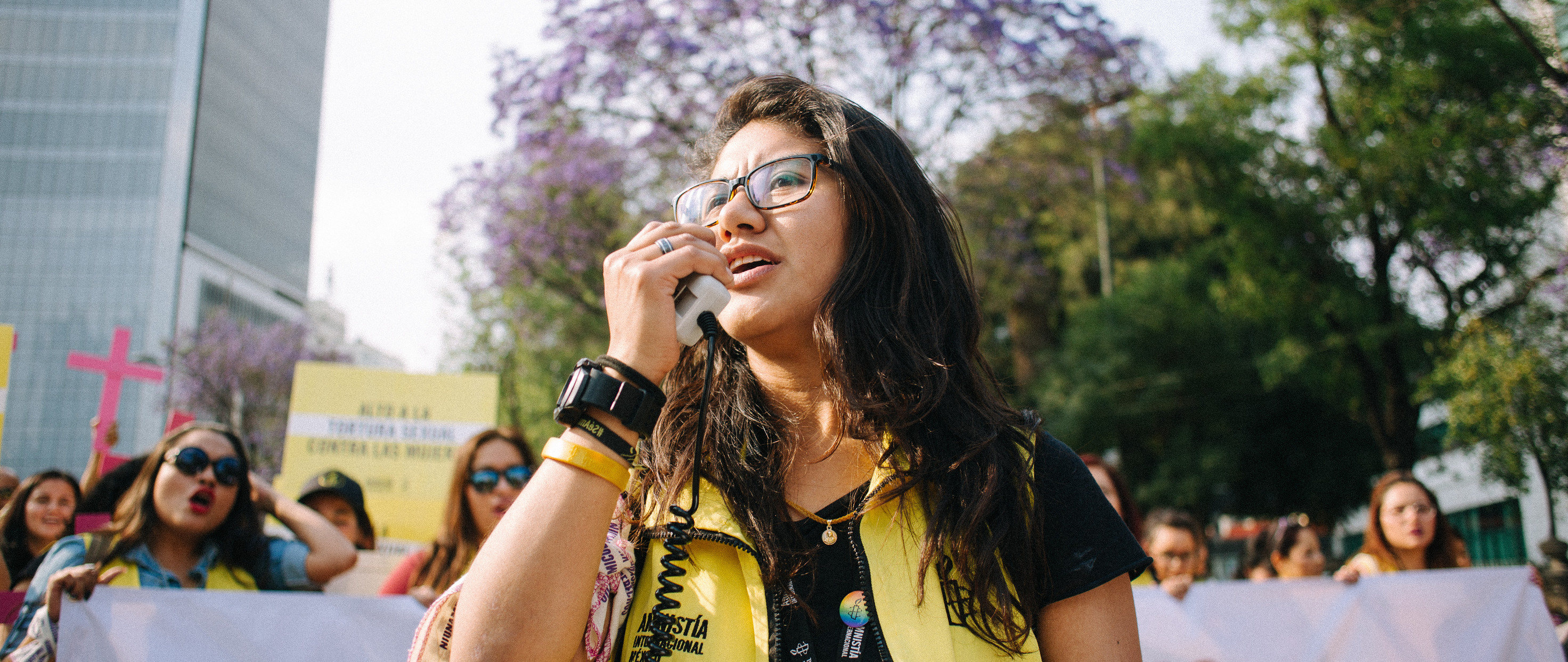 A woman speaks into a megaphone at a protest in Mexico.