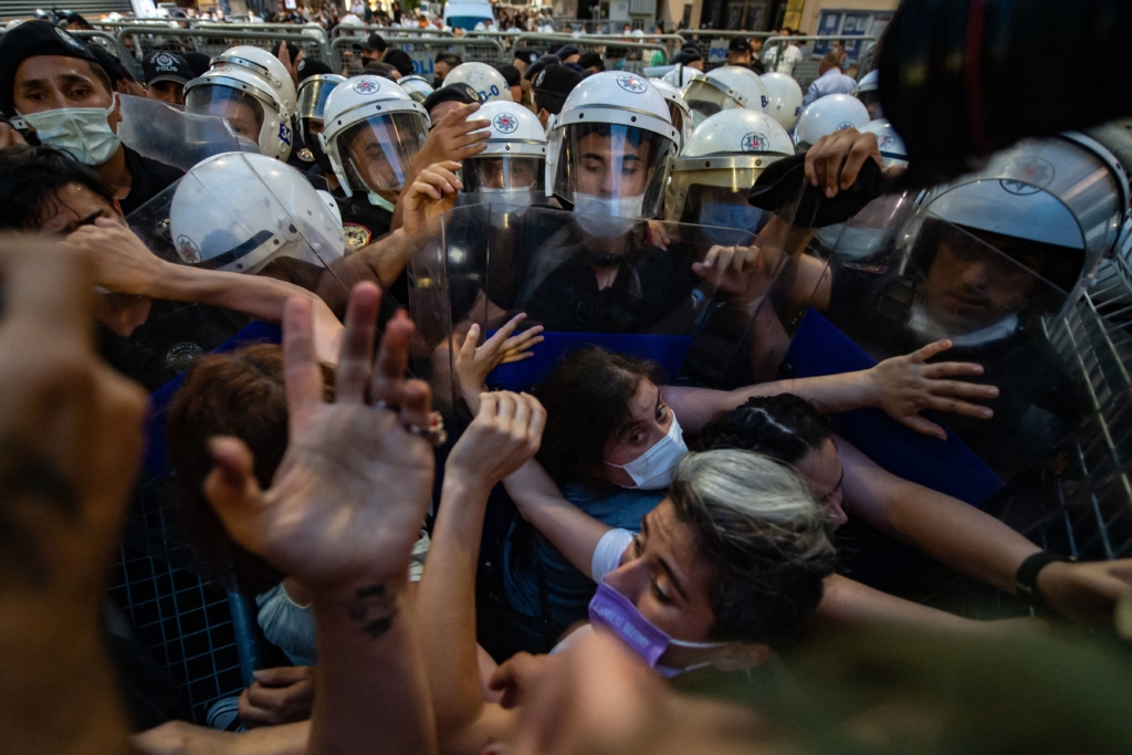 Women demonstrators clash with Turkish police as they protest against Turkey's decision to withdraw from the Istanbul Convention, in Istanbul,on July 1, 2021. - Police fired tear gas at protesters in Istanbul demonstrating against Turkey's controversial exit on July 1, 2021 from a treaty combatting femicide and domestic abuse.