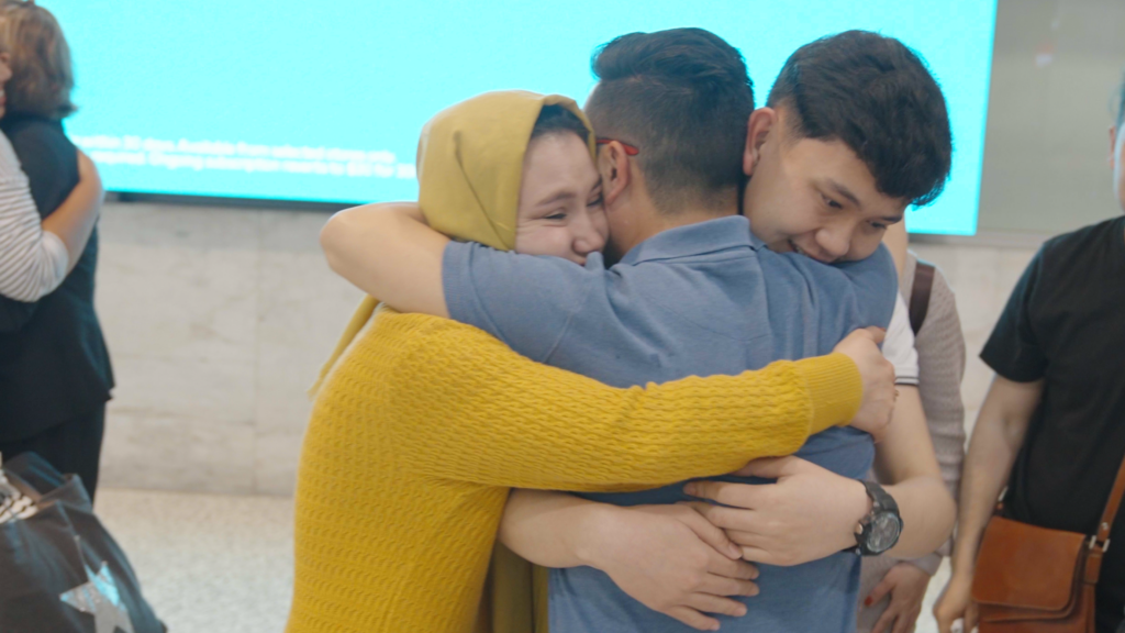 Zaki Haidari hugs his family